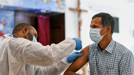 FILE PHOTO. A man receives a dose of a vaccine against the coronavirus disease (Covid-19) at St. Paul's Church in Abu Dhabi, United Arab Emirates. © REUTERS/Khushnum Bhandari