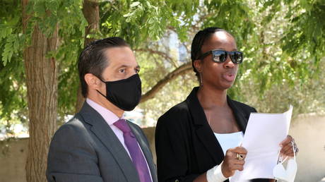 Janice McAfee, wife of John McAfee, with lawyer Javier Villalba, speaks to media in Sant Esteve Sesrovires, Spain