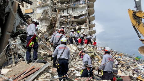 Rescue crews respond at the site after a partial building collapse in Surfside near Miami Beach, Florida, US, June 25, 2021.