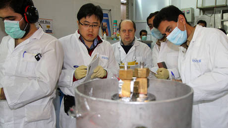 FILE PHOTO: IAEA inspectors working at an Iranian nuclear facility. © AFP / IRNA / Kazem Ghane