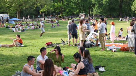 People enjoy socializing without masks in Central Park in the Manhattan borough of New York City