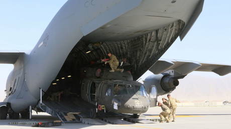 A UH-60L Blackhawk helicopter is loaded into a US Air Force C-17 Globemaster III during the withdrawal of American forces in Afghanistan, June 16, 2021.