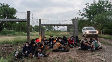 Central American migrants near the Rio Grande River in La Joya, Texas, are shown after being apprehended by US Border Patrol officers in June.