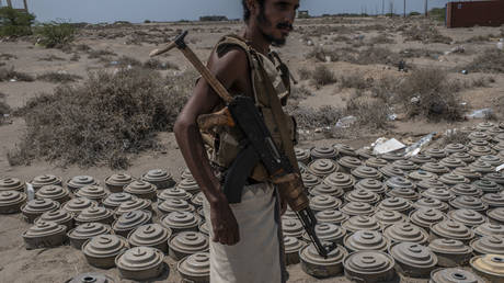 A fighter with the Tariq Salah Forces, a militia aligned with Yemen's Saudi-led coalition-backed government, shows Houthi rebel landmines the militia had recovered, at an outpost a few kilometers from the frontline on September 22, 2018 in Al-Himah, Yemen.