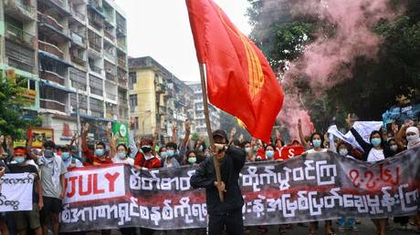 Protesters hold banners as they take part in a demonstration against the military coup and to mark the anniversary of 1962 student protests against the country's first junta in Yangon on July 07, 2021. © Stringer/Anadolu Agency via Getty Images