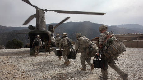 US soldiers board an Army Chinook transport helicopter after it brought fresh soldiers and supplies to the Korengal Outpost on October 27, 2008 in the Korengal Valley, Afghanistan. © John Moore/Getty Images