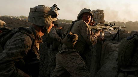 FILE PHOTO: U.S. Marines fire during a Taliban ambush as they carry out an operation to clear an area in Helmand province, Afghanistan, October 9, 2009. © REUTERS/Asmaa Waguih