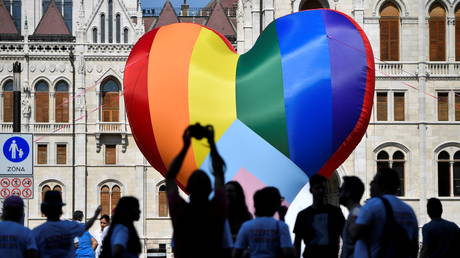 People gather in front of a huge rainbow balloon put up by members of Amnesty International and Hatter, an NGO promoting LGBT rights, at Hungary's parliament in Budapest, Hungary, July 8, 2021. © REUTERS/Marton Monus