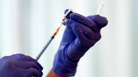 FILE PHOTO: A medical worker fills a syringe with a dose of the Pfizer-BioNTech coronavirus vaccine.