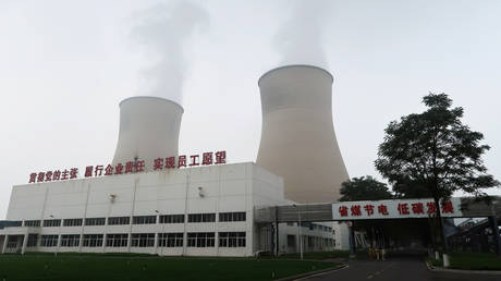 Water vapour rises from cooling towers of a China Energy ultra-low emission coal-fired power plant in Sanhe, Hebei province, China