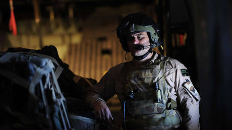 An Australian soldier on board a C-130 military airplane prepares for landing during a flight from Kabul to Kandahar on July 31, 2010.