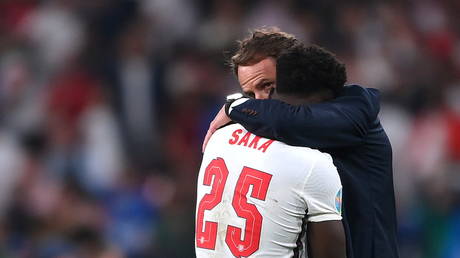 England manager Gareth Southgate consoled Bukayo Saka after his penalty miss. © Reuters