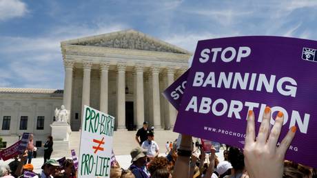 FILE PHOTO: Abortion-rights activists are shown rallying outside the US Supreme Court in 2019.