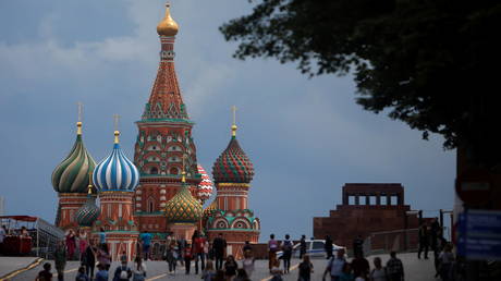 People walk across Red Square in Moscow, Russia
