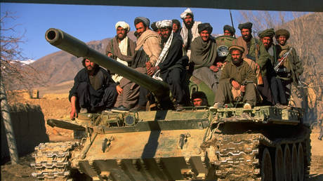 Taliban fighters w. tank at HQ taken fr. opposition Hekmatyar mujahedin by radical Islamic cleric-led faction on top in civil war, nr. govt-held Kabul. © Robert Nickelsberg/Getty Images