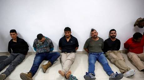 FILE PHOTO: Suspects in the assassination of Haitian President Jovenel Moïse are shown to the press on July 8 in Port-au-Prince.