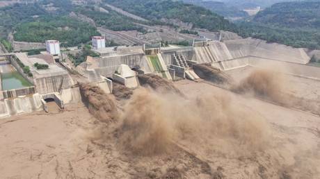 FILE PHOTO: An aerial photo shows water being released from the Xiaolangdi Reservoir Dam in Luoyang in China's central Henan province on July 5, 2021 © AFP