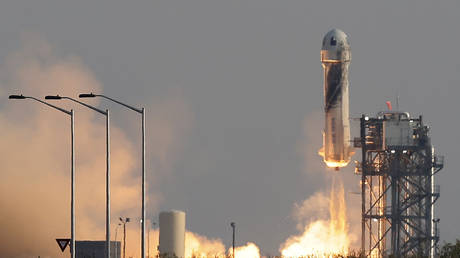 Blue Origin's first manned space flight is shown launching on Tuesday near Van Horn, Texas.