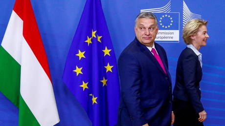 Hungarian Prime Minister Viktor Orban walks with European Commission President Ursula von der Leyen