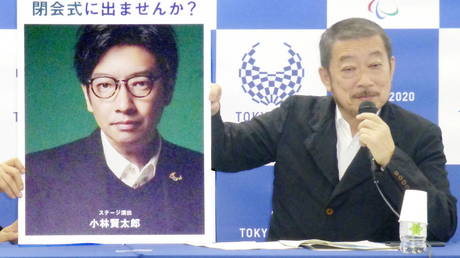 FILE PHOTO: Tokyo Olympics creative chief Hiroshi Sasaki, who has since resigned over controversial remarks, displays a portrait of the now-fired opening ceremony director Kentaro Kobayashi at a news conference in Tokyo, Japan.