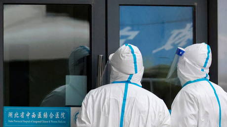 Staff members in protective suits stand at Hubei Provincial Hospital of Integrated Chinese and Western Medicine in Wuhan, Hubei province, China January 29, 2021.