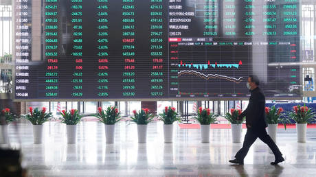 A man wearing a face mask is seen inside the Shanghai Stock Exchange building, Shanghai, China