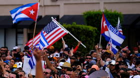 Protesters worldwide waving US flags as ‘symbol of freedom,’ I have bad news for you –  it now stands for Snitch Nation