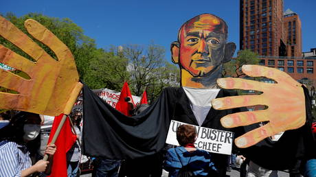 FILE PHOTO: People hold up a puppet of Amazon CEO Jeff Bezos in Union Square during a May Day rally in Manhattan, New York City, US, May 1, 2021