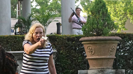 FILE PHOTO: Patricia and Mark McCloskey draw guns on protesters outside their home during a demonstration against St. Louis Mayor Lyda Krewson, in St. Louis, Missouri, June 28, 2020.