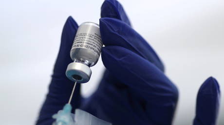 FILE PHOTO: A healthcare worker prepares a Pfizer coronavirus vaccine at a clinic in Los Angeles, California.