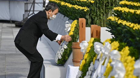 Japan's Prime Minister Yoshihide Suga places a wreath on a memorial for victims on the 76th anniversary of the world's first atomic bombing, in Hiroshima, Japan, August 6, 2021.