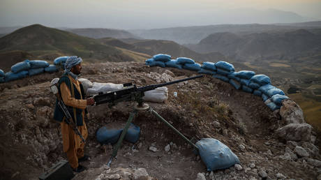 An Afghan militia fighter keeps watch for Taliban insurgents at an outpost in Balkh province, Afghanistan, July 11, 2021.