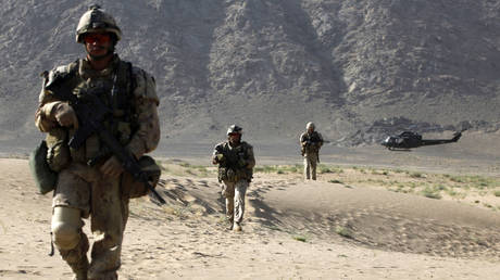 FILE PHOTO: A Canadian CH-146 Griffon helicopter flies behind soldiers during a patrol in the Panjwai district of Kandahar province, in southern Afghanistan, June 27, 2011.