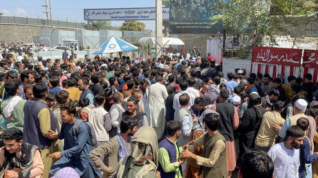 People try to get into Hamid Karzai International Airport in Kabul, Afghanistan, August 16, 2021