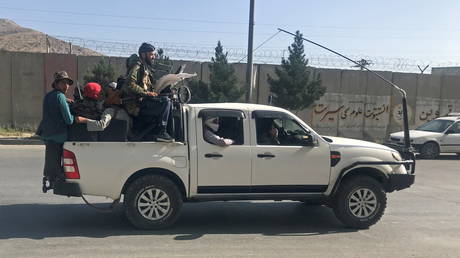 Taliban fighters ride on a vehicle in Kabul, Afghanistan, August 16, 2021. © REUTERS/Stringer
