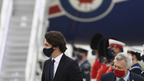 Canada's Prime Minister Justin Trudeau, wearing a face covering due to Covid-19, reacts after landing at Cornwall Airport Newquay, near Newquay, Cornwall, on June 10, 2021. © Alberto Pezzali / POOL / AFP