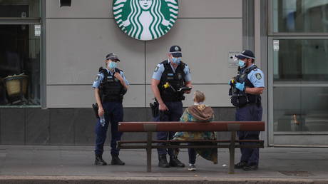Police officers speak with a member of the public during a law enforcement operation to prevent anti-lockdown protesters from gathering . Sydney, Australia,