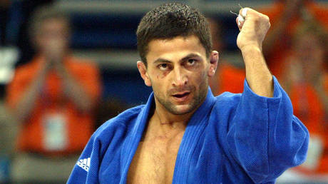 Olympic judo champ &lsquo;attends brother&rsquo;s funeral with cops&rsquo; while &lsquo;facing premeditated murder charges from shootout that killed him&rsquo;