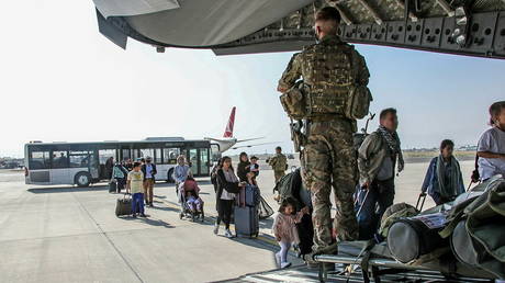 British citizens and dual nationals residing in Afghanistan board a military plane for evacuation from Kabul airport, Afghanistan, August 16, 2021