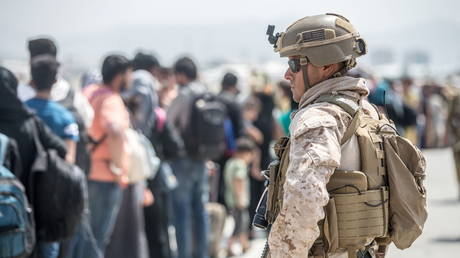 A U.S. Marine provides assistance during an evacuation at Hamid Karzai International Airport, Afghanistan, August 22, 2021.© Reuters / Sgt. Samuel Ruiz