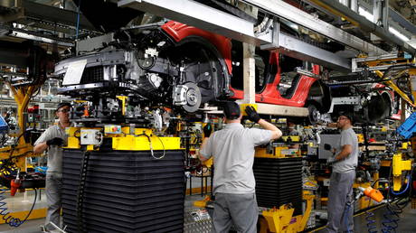 Workers are seen on the production line at Nissan's car plant in Sunderland, Britain