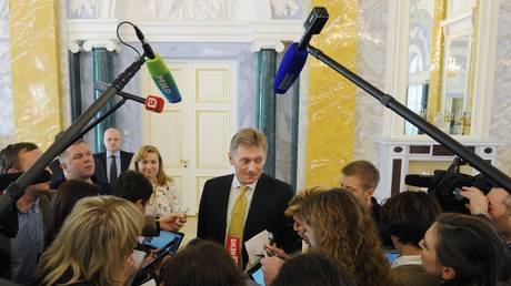 FILE PHOTO: Russian President's Press Secretary Dmitry Peskov, center, answers journalists' questions