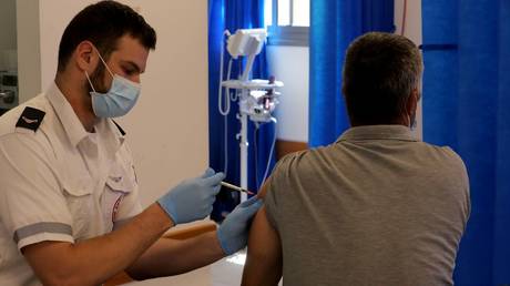 A man receives a third dose of COVID-19 vaccine in central Israeli city of Modiin, Aug. 17, 2021.