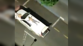 Hostages TIED to cars & bomb traps laid: Heavily armed bank robbers turn Brazilian city into battle zone (VIDEOS)