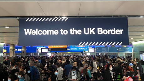 CHAOS at London’s Heathrow Airport as passengers forced to wait for 5 hours in packed queues despite Covid-19 risk (PHOTOS)