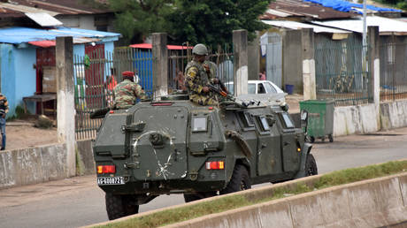 Members of the Armed Forces of Guinea drive through the central neighbourhood of Kaloum in Conakry on September 5, 2021.