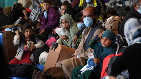 Afghan refugees are processed inside Hangar 5 at Ramstein Air Base in Germany, September 8, 2021. © Olivier Douliery / Pool via REUTERS