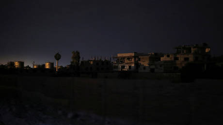 FILE PHOTO: Buildings are seen from of a train traveling through the outskirts of Damascus, Syria.