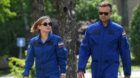 Actress Yulia Peresild and filmmaker Klim Shipenko walk during a training for the upcoming space mission to the International Space Station (ISS) at the Cosmonaut Training Centre in Star City, Moscow region, Russia. © Sputnik / Kirill Kallinikov