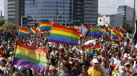 People demonstrate and march with Gay Pride flags during the Warsaw Gay Pride parade in central Warsaw on June 19, 2021. © AFP / Wojtek Radwanski